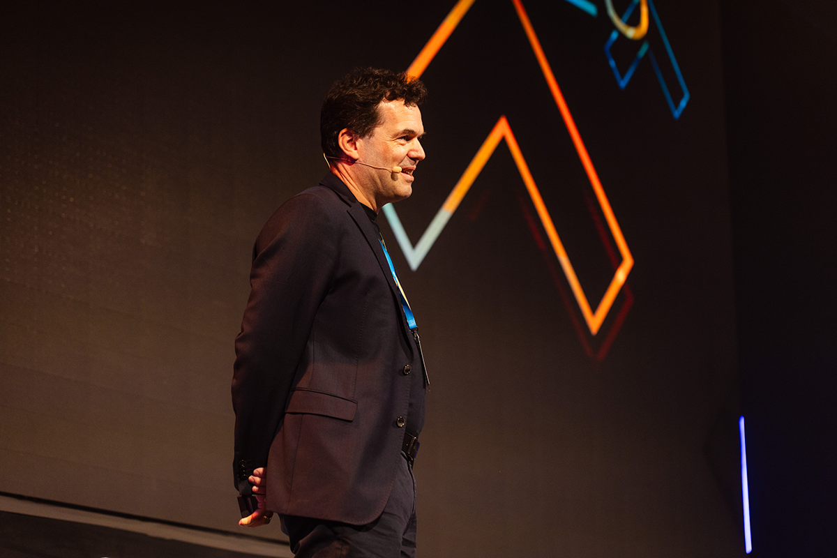 Image showing the NETCONOMY CEO Martin Barzauner holding his keynote at the NETCONOMY Summit 2025.