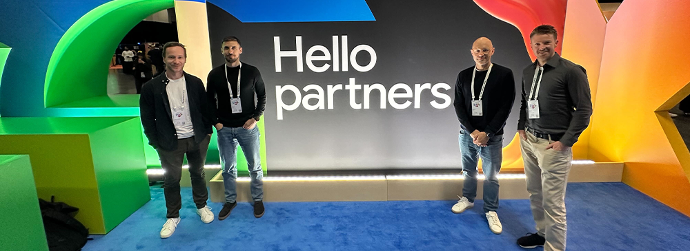 A photo of our four NETCONOMY colleagues present at Google Cloud Next 2026 in front of a Google-branded backwall.